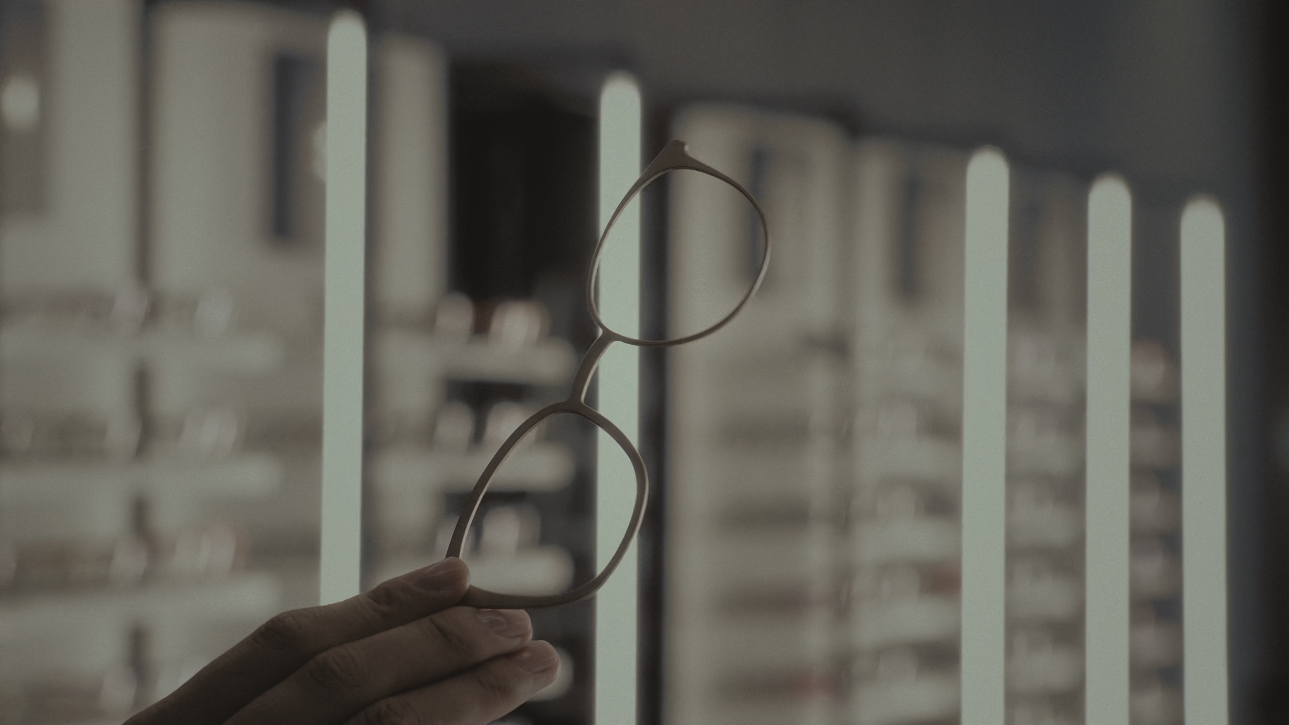 Main article image: image of a hand holding eyeglasses