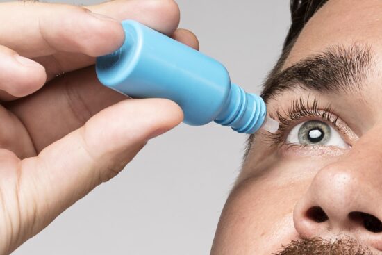 Image of a man using eye drops