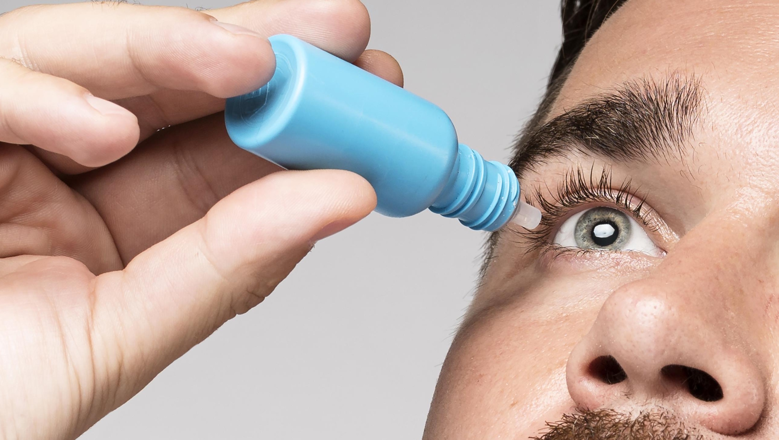 Image of a man using eye drops
