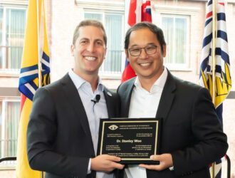 Dr. Martin Spiro, president of the CAO, presents Dr. Stan Woo with the CAO President's Award.