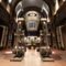 Futuristic Oakley headquarters entrance featuring a large metallic robot-like sculpture with the Oakley logo, industrial design elements, and dramatic lighting in an atrium setting.