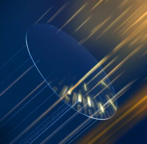 Abstract digital art featuring a translucent circular magnifying glass or lens overlaying diagonal light streaks. The background transitions from deep blue to golden yellow, with bright streaks of light flowing diagonally across the composition
