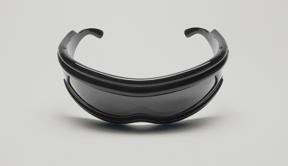 Ray-Ban Ultra Wrap sunglasses shown from the front displaying their mask-like silhouette with wide curved lenses and sleek black frames against a white background