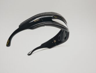 Ray-Ban Ultra Wrap 001 sunglasses with dramatic curved black frames and striped detailing, floating against a white background