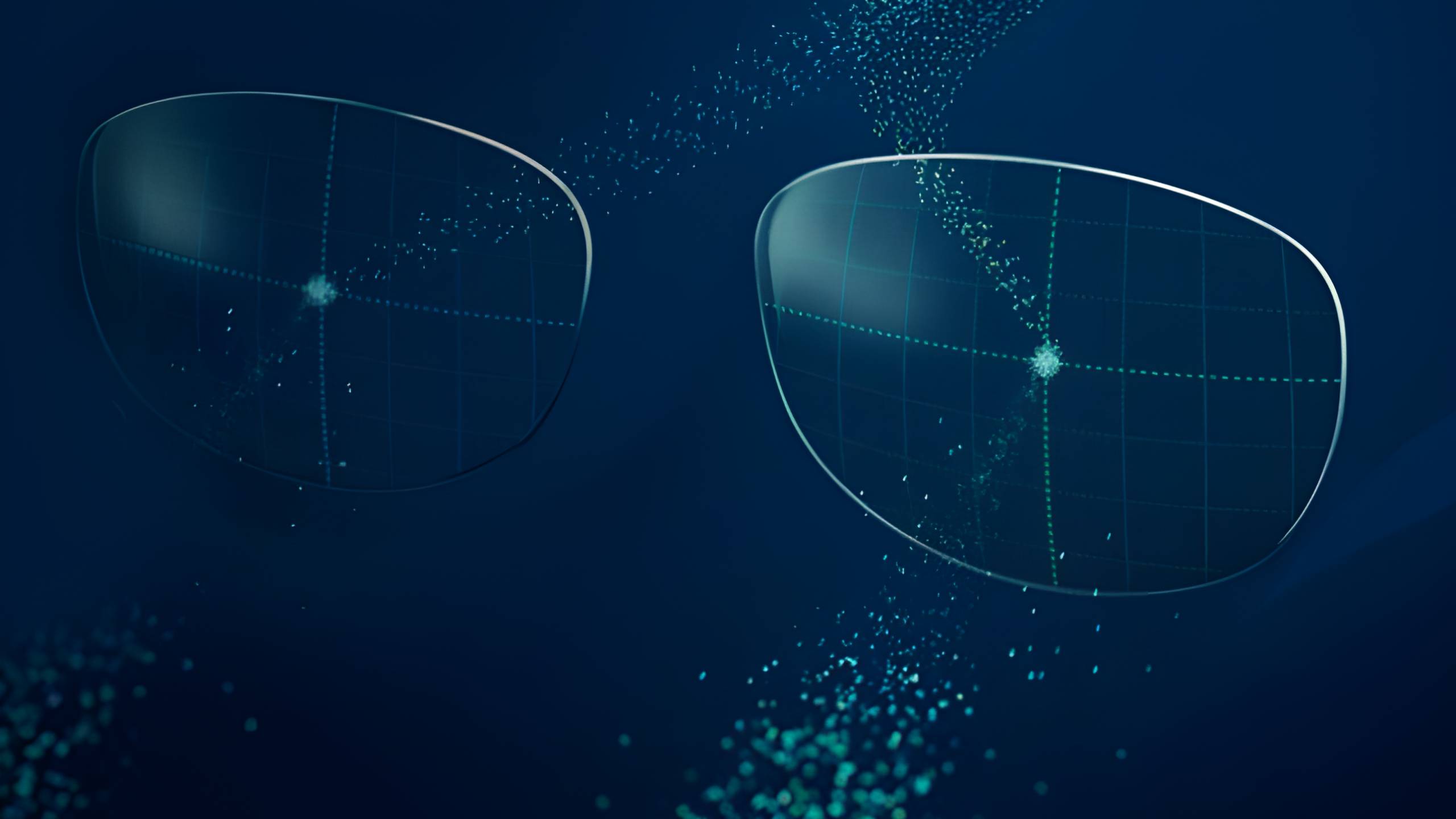 Main article image: Image of two translucent eyeglass lenses floating in a dark blue digital space, surrounded by scattered particles of light and geometric grid patterns. The image suggests a smart lens technology with a high-tech, futuristic aesthetic
