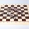 Two pairs of eyeglasses from the LOOK collection placed artistically on a wooden chess board - one pair in translucent gray-blue and another in deep purple, demonstrating the strategic precision and thoughtful design philosophy of Italian eyewear craftsmanship.