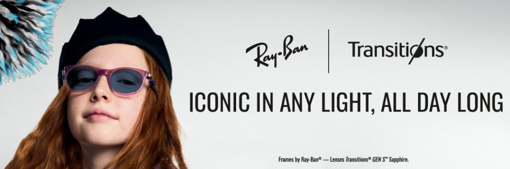 A young woman with long reddish-brown hair wearing a black beret and purple-framed Ray-Ban sunglasses with Transitions lenses. She's looking directly at the camera with a slight smile. The image includes the Ray-Ban and Transitions logos with text reading 'ICONIC IN ANY LIGHT, ALL DAY LONG' and 'Frames by Ray-Ban® — Lenses Transitions® GEN S™ Sapphire.
