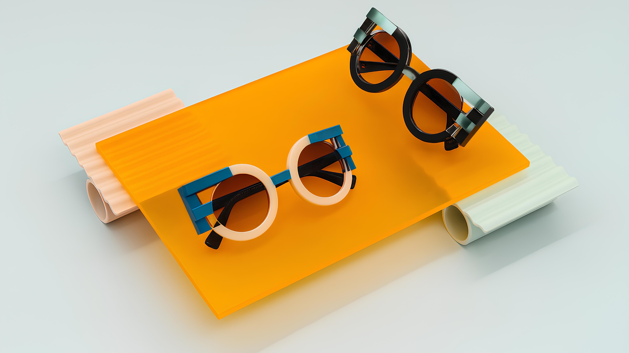 Artistic display of FACE A FACE sunglasses on colorful acrylic platforms - two pairs of avant-garde eyewear with geometric frames in pink, blue, and black colors arranged on bright orange, peach, and mint green translucent surfaces.