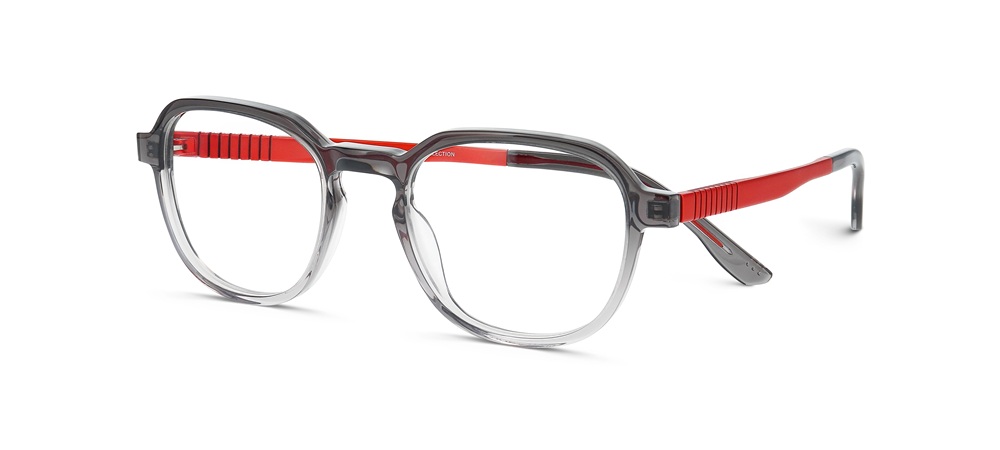 Close-up product shot of Prodesign Denmark PROFLEX ACE eyeglasses featuring a clear grey acetate frame with distinctive red detailing on the temples and interior surfaces. The modern round-square hybrid shape showcases the brand's signature layered acetate construction and titanium flex-zone hinges.