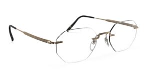 Lunettes sans monture Silhouette Visionary en titane bronze/doré avec une forme de verre angulaire et géométrique, un pont nasal sculptural et des branches ultra-fines, photographiées en trois-quarts sur fond blanc.