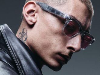 Profile view of a man wearing Ray-Ban smart glasses with tinted lenses and a black leather jacket, showcasing the stylish everyday wearability of the AI glasses