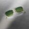 Blackfin Aero Loop Infinity sunglasses with geometric squared lenses and green gradient tinting, featuring ultra-minimalist titanium construction with geometric bridge design, photographed on a textured grey surface