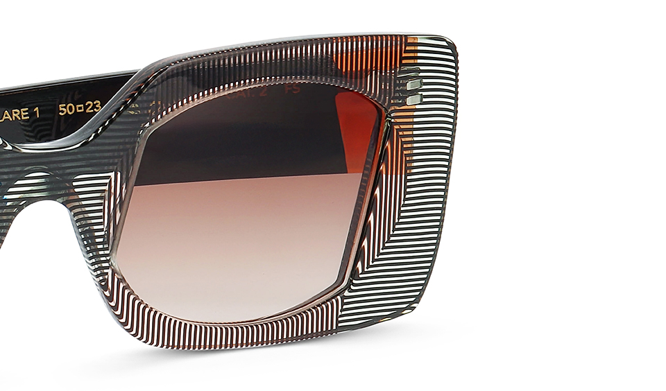 Close-up of FACE A FACE FLARE sunglasses featuring distinctive striped acetate frame with geometric line patterns and gradient brown lenses