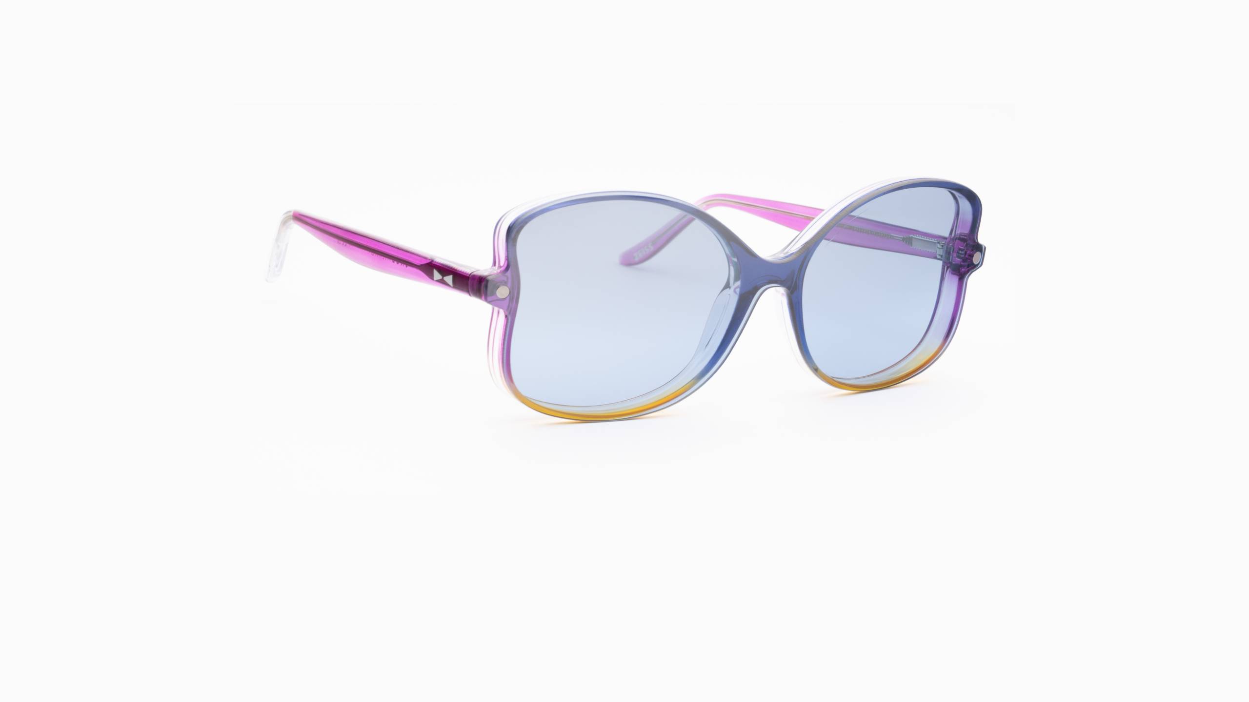 Three-quarter view of SNOB Milano Butterfly glasses highlighting the vibrant fuchsia, blue and yellow color blend