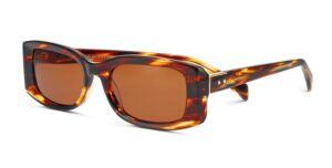 Modèle de lunettes de soleil William Morris présentant une monture en acétate écaille avec des verres dégradés bruns. La monture rectangulaire présente de riches motifs écaille ambrés et bruns, représentant le modèle RITZ de la collection de luxe.