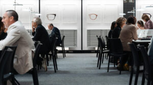 Business professionals and buyers viewing eyewear collections at Marcolin display stands during SILMO Paris 2025 optical trade exhibition