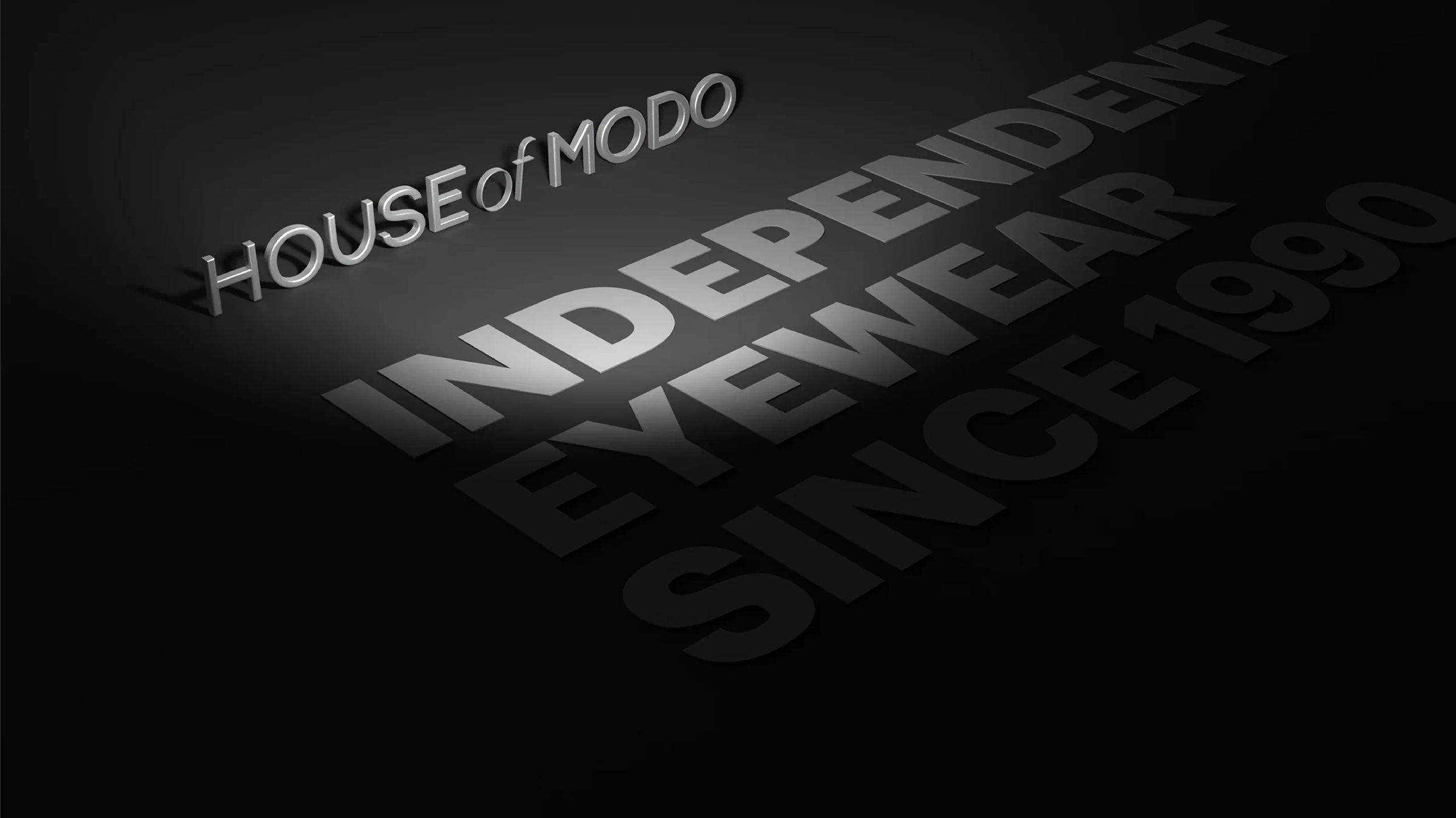 Three-dimensional House of Modo logo with the words Independence, Eyewear, Design and Storytelling on black background