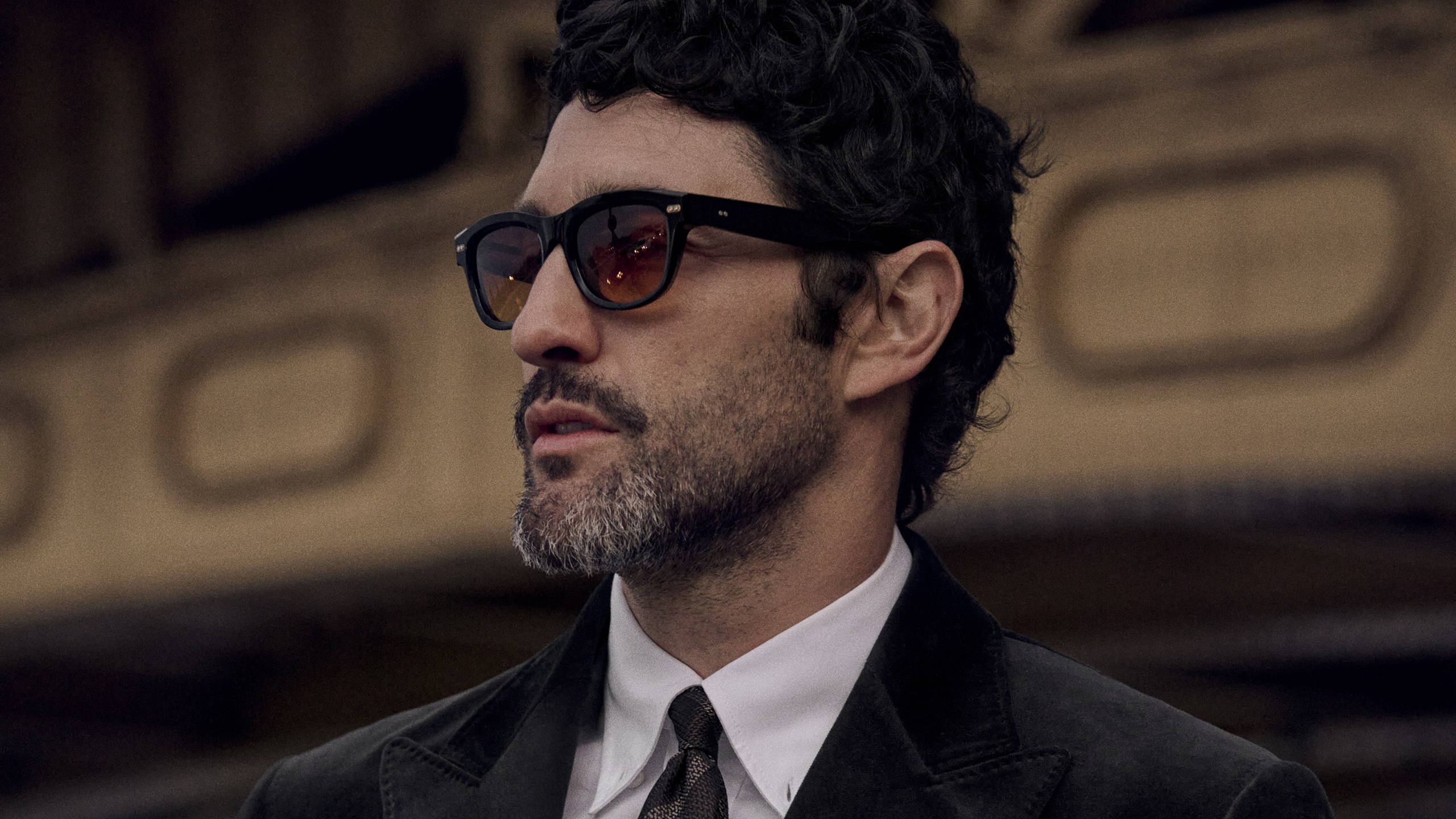 Man wearing Brunello Cucinelli black acetate sunglasses with formal attire