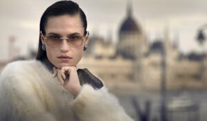 Woman wearing Brunello Cucinelli frameless optical glasses with gold accents
