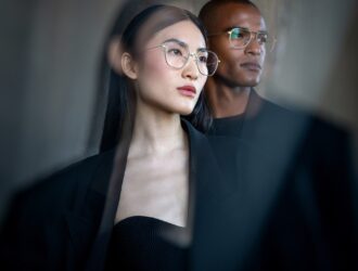 Models wearing Blackfin Pacific titanium eyeglasses in modern professional setting