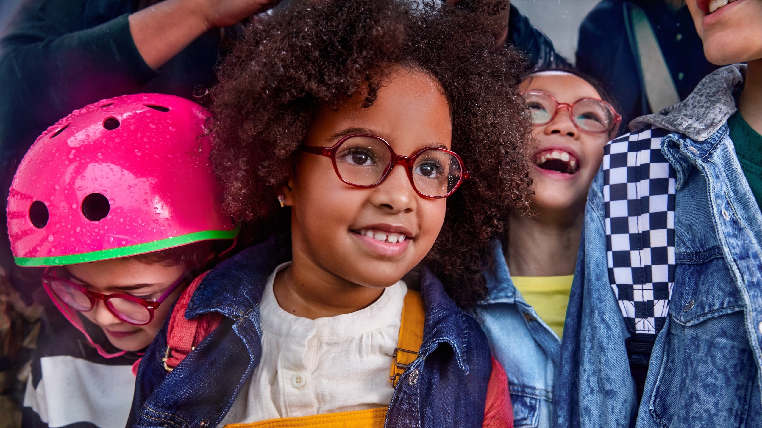 Groupe diversifié d'enfants portant des lunettes souriant ensemble