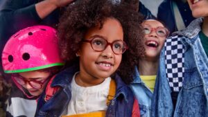 Diverse group of children wearing eyeglasses smiling together