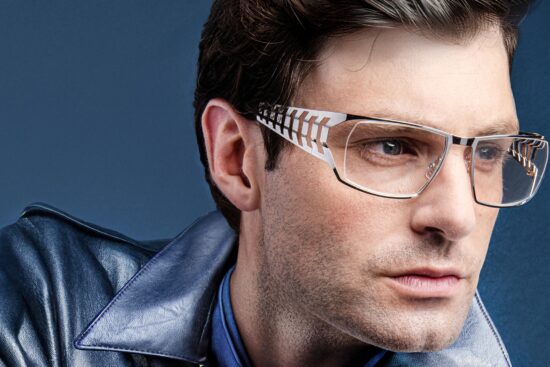 Model wearing J.F. Rey ICONIC40 limited edition eyeglasses showcasing the signature scorpion-inspired articulated temple design