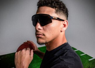 Patrick Mahomes wearing Oakley Sutro Lite Sweep sunglasses while holding a football