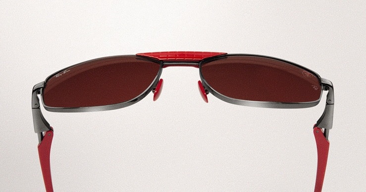 Close-up rear view of Ray-Ban for Scuderia Ferrari sunglasses showing distinctive red sweat-bar detail across the top of the frame