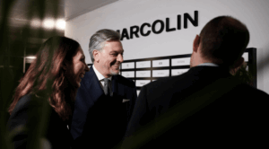 Executive greeting guests at Marcolin Barcelona showroom opening