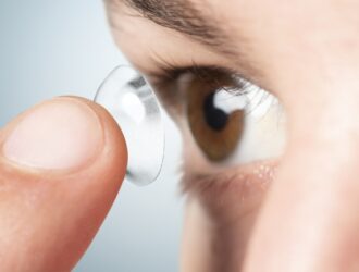 Person about to apply a contact lens for vision correction