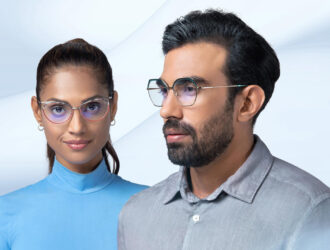 Woman and man wearing modern ZEISS progressive eyeglasses with blue light filtering lenses against a clean white background