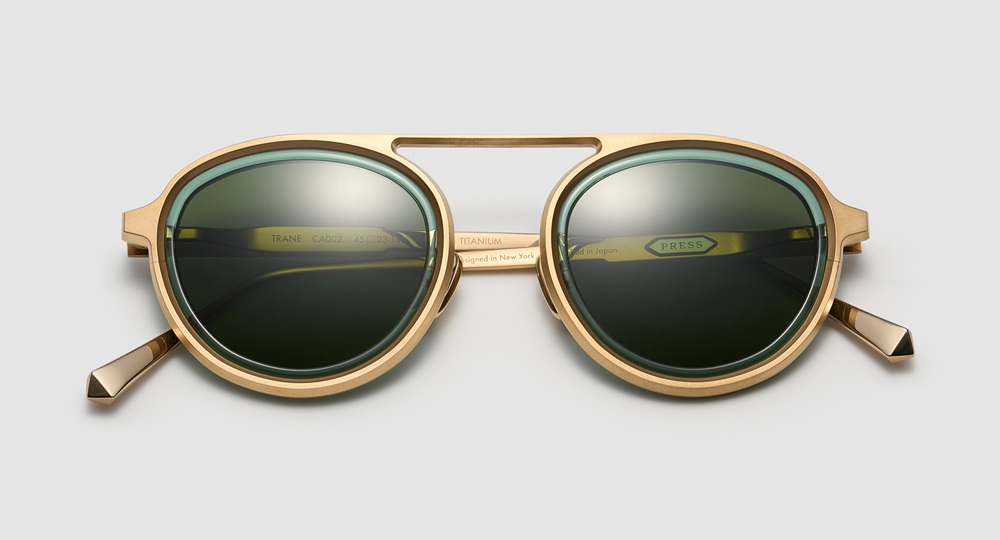 PRESS Trane sunglasses in rose gold titanium with turquoise acetate and green lenses