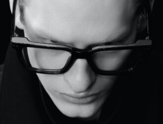 High-angle, black-and-white close-up of Miga Studio Takumi frames, highlighting the textured metallic top bar and structural precision.