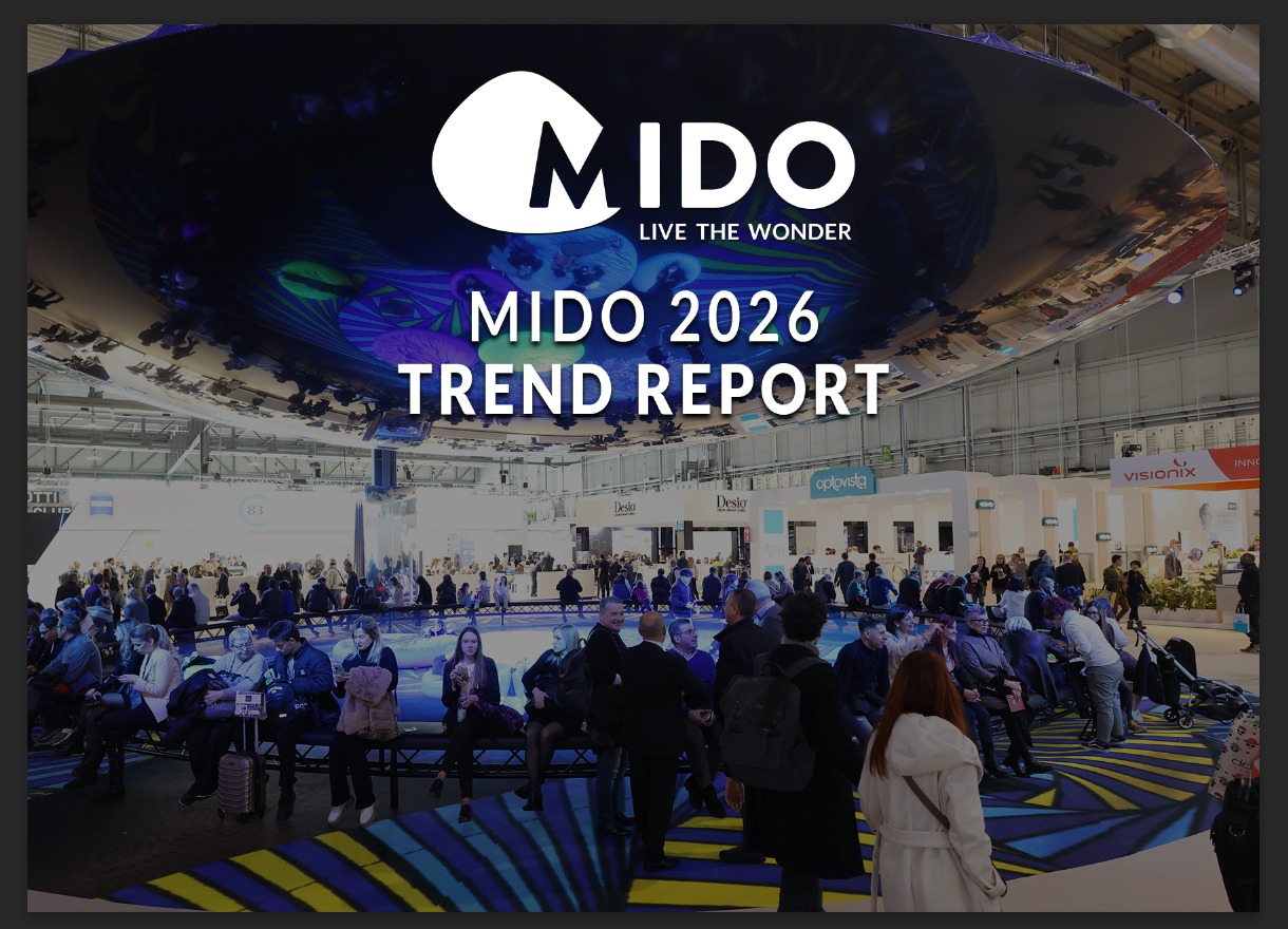Large exhibition hall at MIDO 2026 eyewear trade show with attendees gathered around a circular blue-lit stage area. The MIDO logo with tagline 'Live the Wonder' and text 'MIDO 2026 TREND REPORT' overlays the scene. Exhibition booths from brands like Optovisol, Desio, and Visionix visible in the background.