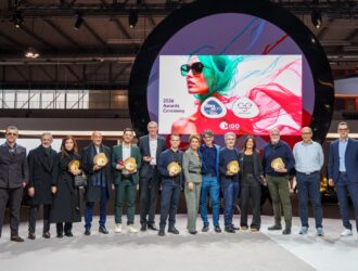 MIDO Awards 2026 winners pose with President of MIDO and ANFAO, Lorraine Berton, on stage holding their awards in front of the 2026 Awards Ceremony backdrop