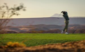 JR Smith wearing Oakley Golf apparel swinging club