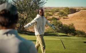 JR Smith in Oakley Golf apparel with arms outstretched on green