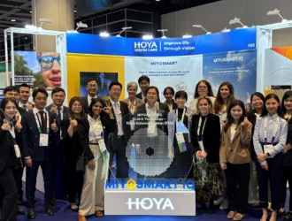 A large group of HOYA Vision Care representatives standing together at the MiYOSMART iQ launch event at the Asia-Pacific Academy of Ophthalmology Congress in Hong Kong.