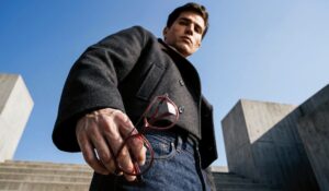 Man holding red J.F. REY eyewear in urban setting