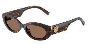 Dolce&Gabbana DG4537 sunglasses in havana tortoiseshell acetate with brown lenses, featuring a softly contoured oval silhouette and a gold-toned Sacred Heart emblem on the wide temple. Three-quarter product view on white background.