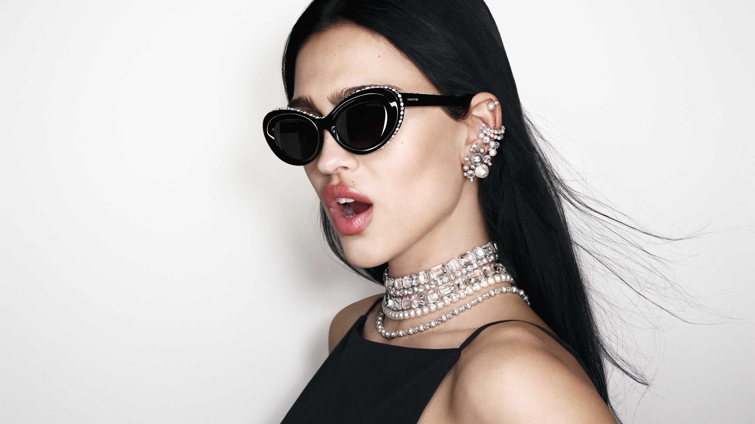 Amelia Gray wearing Swarovski SS26 crystal-embellished cat-eye sunglasses with pearl and crystal jewelry