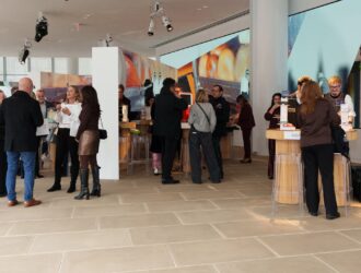 Buyers and exhibitors networking at the Italian Eyewear Exhibition showroom floor during the daytime business session.