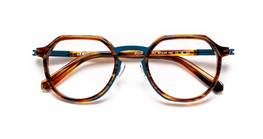 J.F. Rey SLEDGE series eyeglasses model JF3134 in tortoiseshell and teal, folded flat. The geometric octagonal acetate frames combine warm amber tortoise on the front with a contrasting teal metallic inner rim and temples, showcasing the Flex hinge detail.