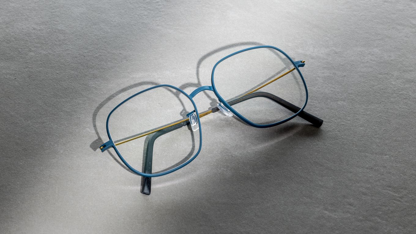 Blackfin Pacific collection optical frame in Deep Lake titanium, flat lay on grey background