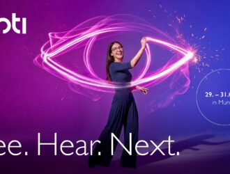 A promotional campaign graphic for opti 2027 featuring a smiling woman in glasses standing against a vibrant purple and blue gradient background. She is holding a glowing, neon pink light trail that forms the shape of a stylized eye around her. The image includes the "opti" logo, the campaign claim "See. Hear. Next.", and the event details: "29. – 31.01.27 in Munich."