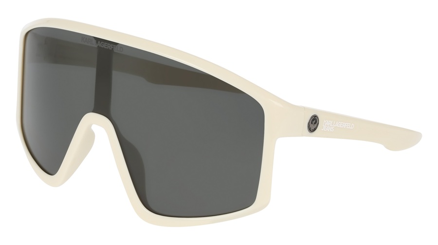 Lunettes de soleil Karl Lagerfeld Jeans x Dragon modèle Amped à monture bouclier blanche avec verres fumés, détails co-brandés sur le verre et la branche, fabriquées en matériaux bio-injectés. Collaboration Printemps-Été 2026.