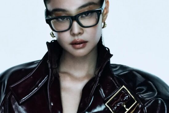 Ray-Ban global ambassador Jennie wearing black rectangular Ray-Ban frames and a dark patent leather jacket in the brand's campaign