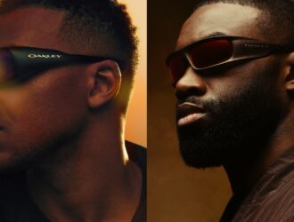 A side-by-side profile view of Kylian Mbappé and Jaylen Brown wearing their signature Oakley eyewear. Mbappé (left) wears the dark Permian frames with purple-tinted lenses against a warm orange glow. Brown (right) wears the cocoa brown Highland frames with red-orange Prizm lenses against a smoky, atmospheric background.