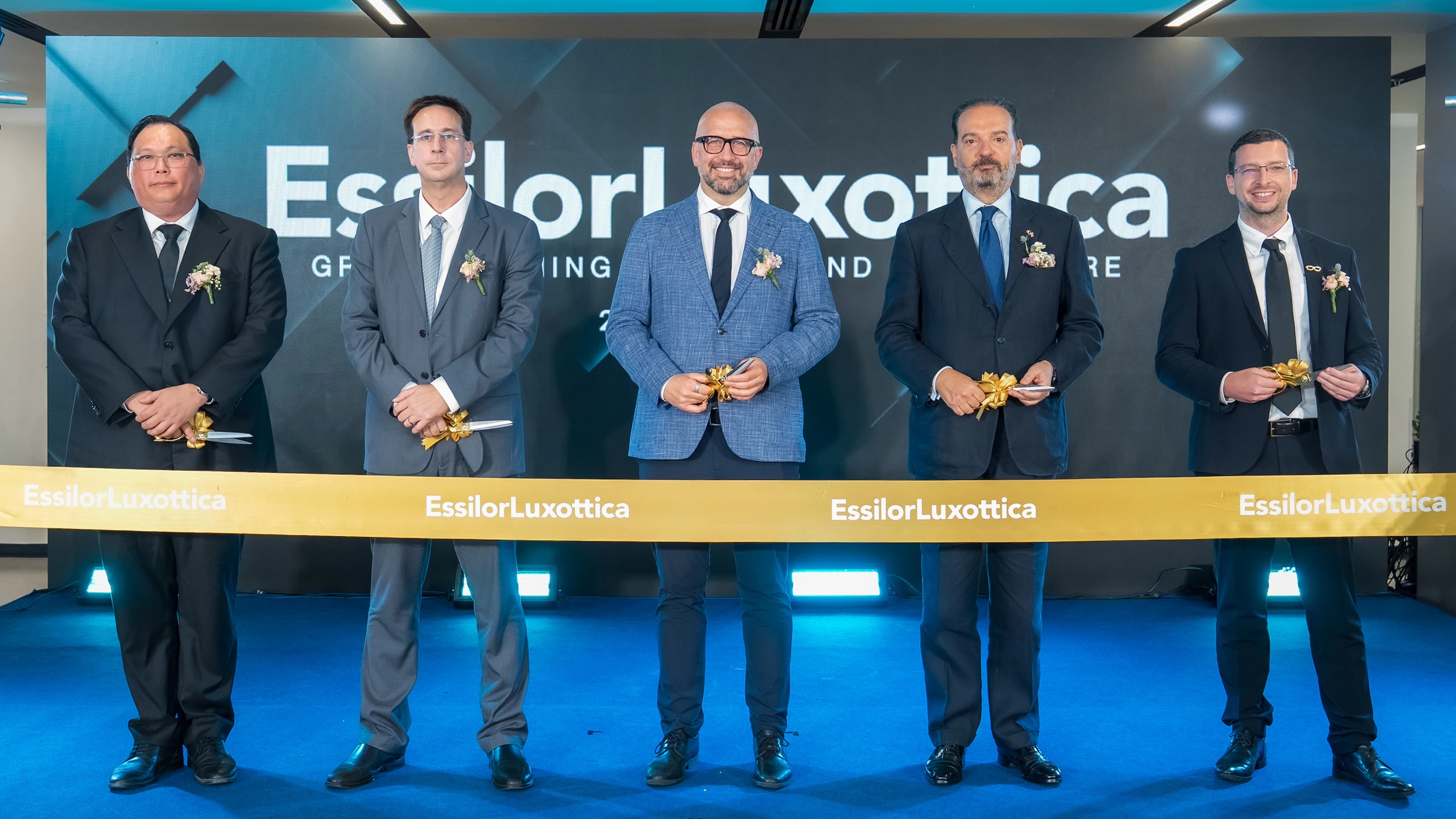Executives stand behind a ceremonial ribbon at the opening of EssilorLuxottica’s new R&D hub in Lat Krabang, Thailand, marking a major milestone in the company’s innovation journey for next-generation vision care, wearables, and medical technologies.